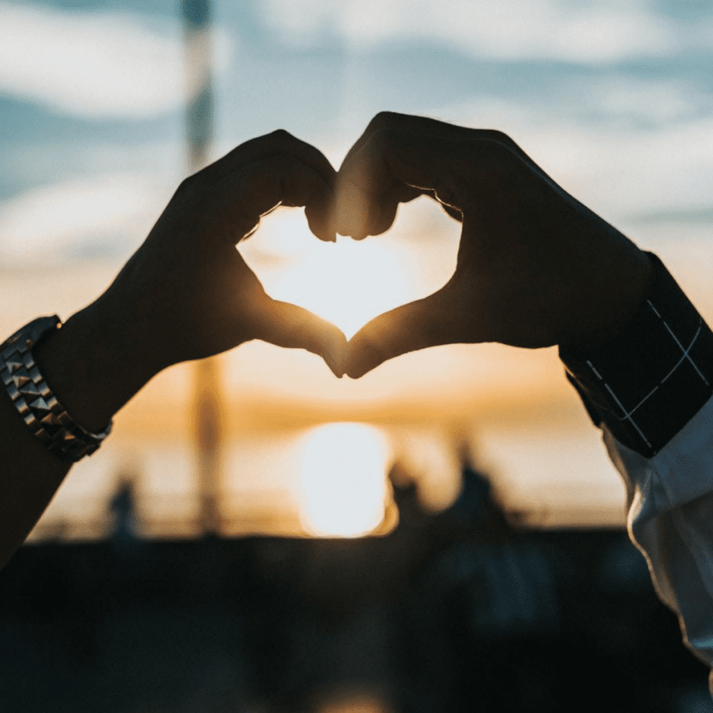 A person making a heart with their hands